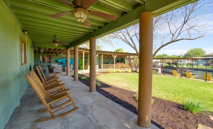 The covered front porch welcomes you to this waterfront oasis, offering a cozy spot to relax and take in the serene surroundings of Lake LBJ.