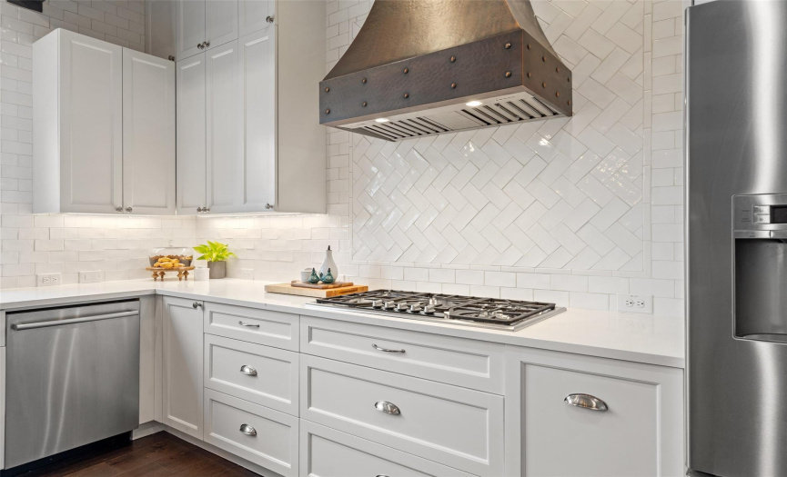 Sleek counters and top-tier appliances make cooking in this kitchen a special treat!