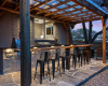 Enjoy dining or having drinks at the covered outdoor kitchen and bar area. 