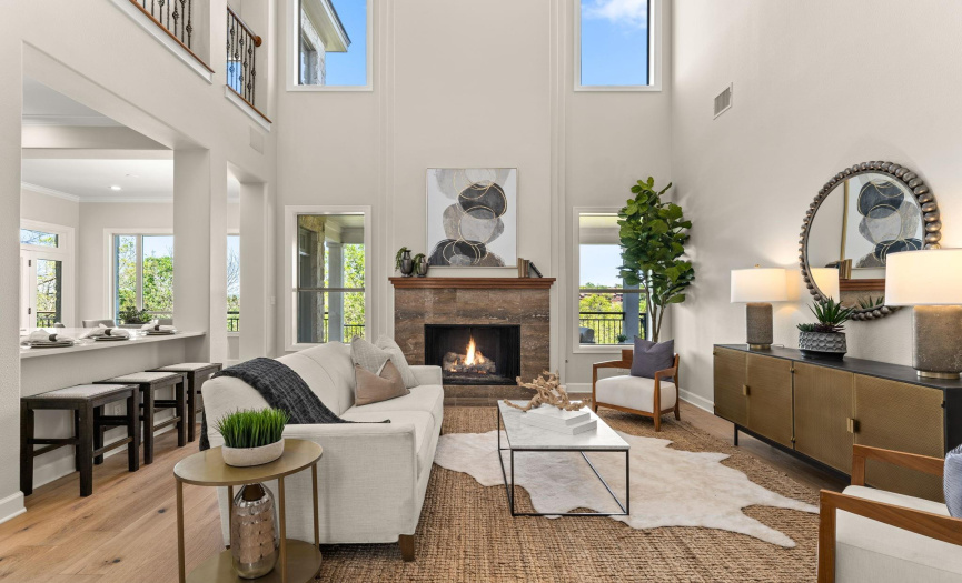 This great room features high ceilings, a fireplace, and fresh paint.