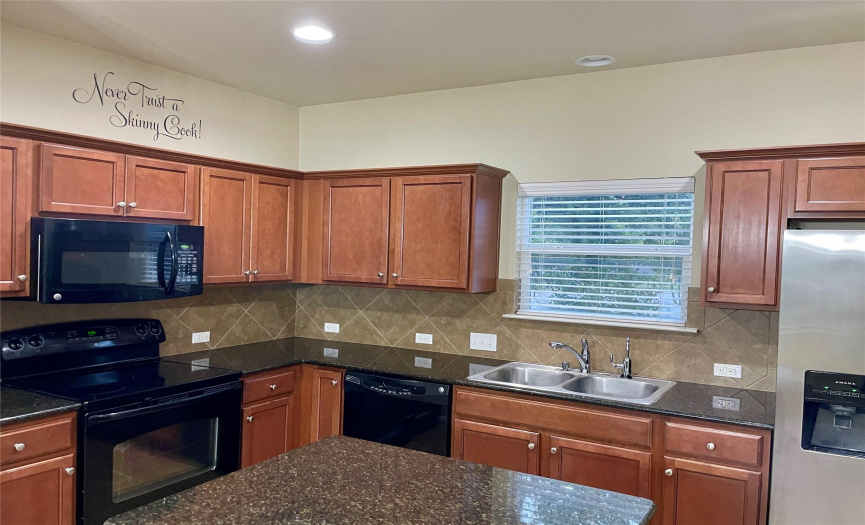 Upgraded cabinets and granite countertops at kitchen