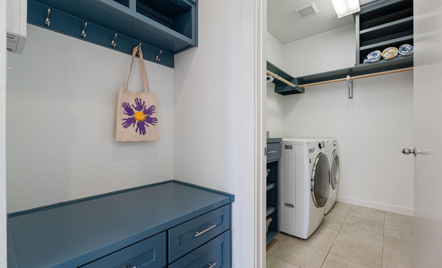 Upgraded entry nook and utility room feature custom built-in storage and shelving