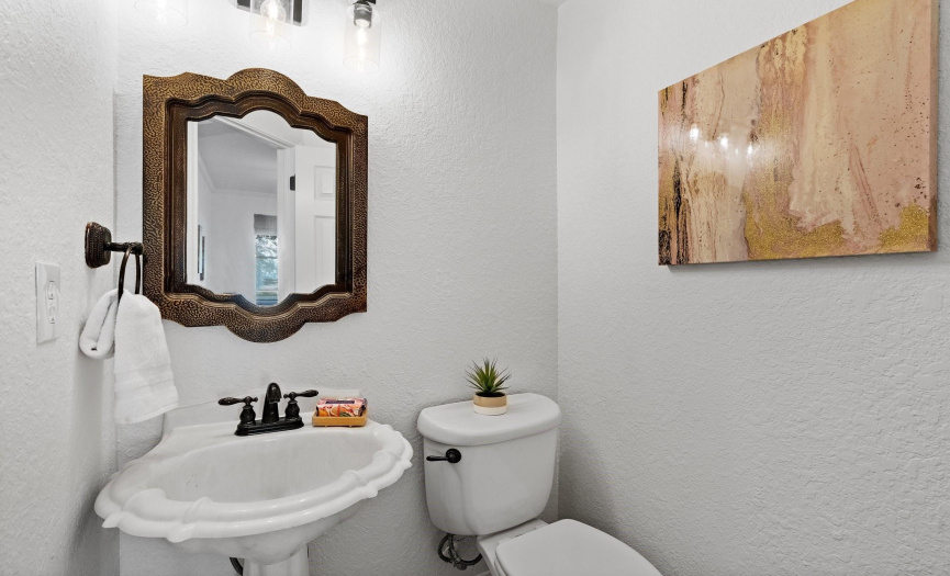 The half bath on the main floor offers convenience for guests, featuring modern fixtures and elegant decor.