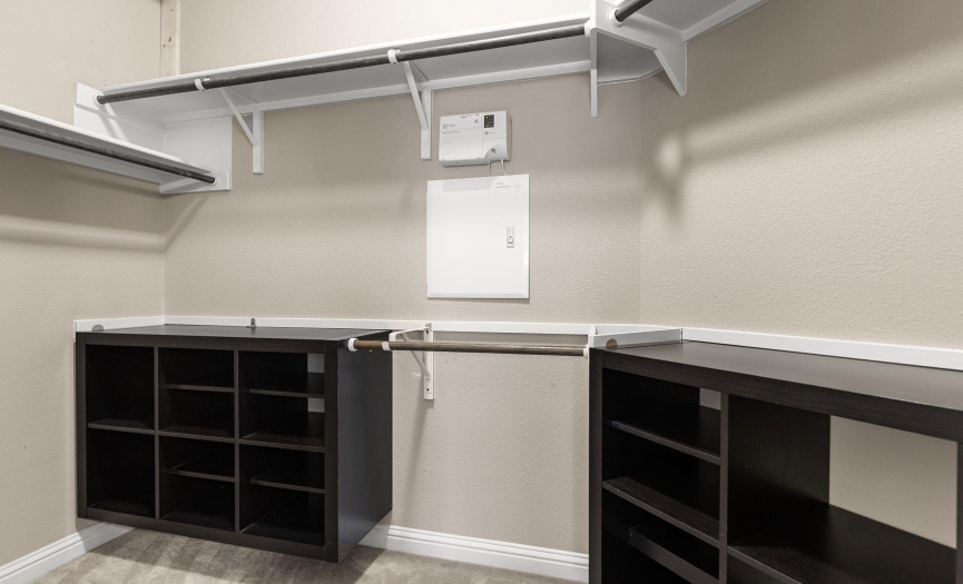 Primary walk-in closet with organization system