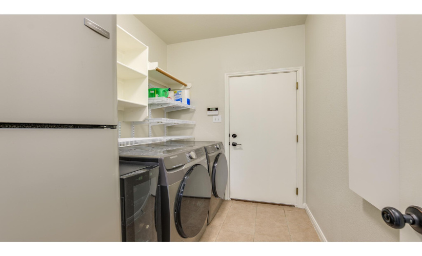 The in home laundry room is located at the garage entry and provides space for a second fridge. 