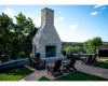 Enjoy a striking outdoor fireplace with scenic hill country vistas. 