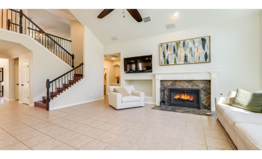 The welcoming living room offers an abundance of space to gather with friends and family in front of the cozy gas log fireplace. 
