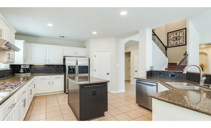 The home chef will love all the counter space & cabinetry storage in the bright and spacious kitchen. Freshly painted cabinetry showcases updated modern pulls. 