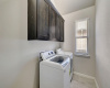 The laundry room features built-in cabinetry and a window that allows for natural light!
