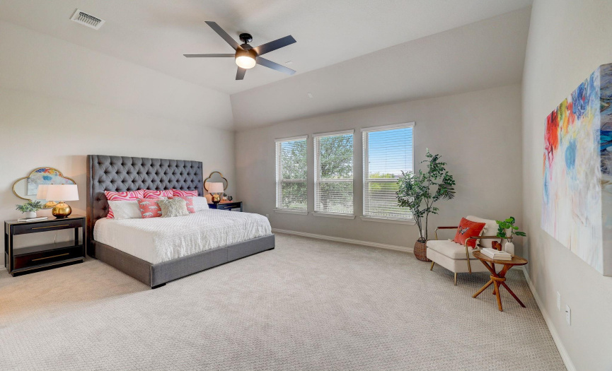 The oversized primary bedroom is perfect to cuddle up after a long day of work and overlooks the backyard. Brand new ceiling fan and carpet installed March 2024.