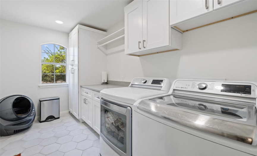 The laundry room contains washer/dryer connections, and cabinet/countertop/shelf space.