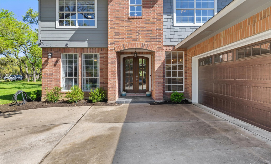 The front porch features double doors leading to the entryway of the home.