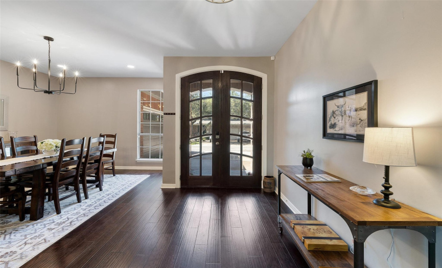Hardwood flooring, high ceilings, and a graceful formal dining area right off the entryway of the home.