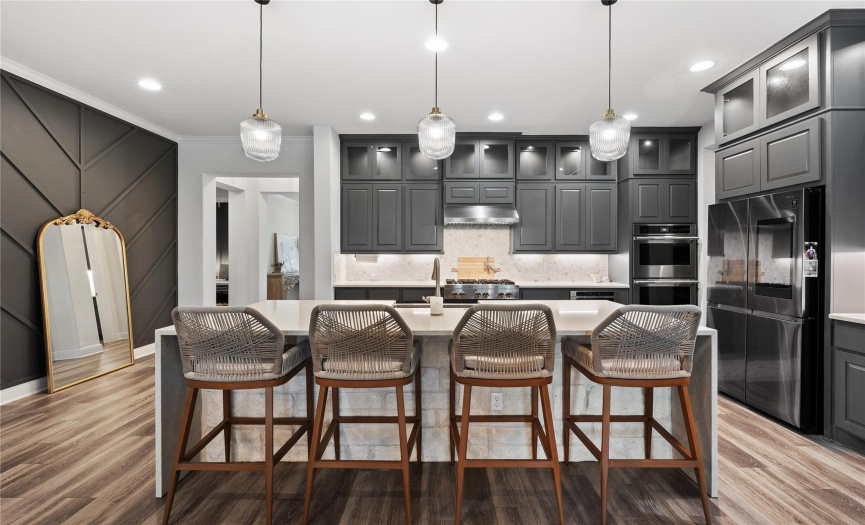 Massive kitchen island, upgraded pendants, Jenn-Air appliances and upper cabinets make this space beyond gorgeous