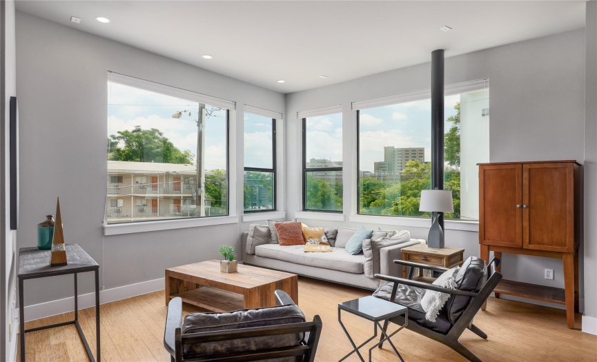 Large windows let in the views of greenery and downtown scenery.