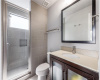 The en suite bath features a large walk-in shower and modern fixtures/finishes.
