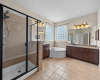 Lovely primary bathroom with two sinks, large walk-in shower, jetted tub