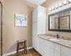 This guest bathroom also features a large shower and linen cabinet.  