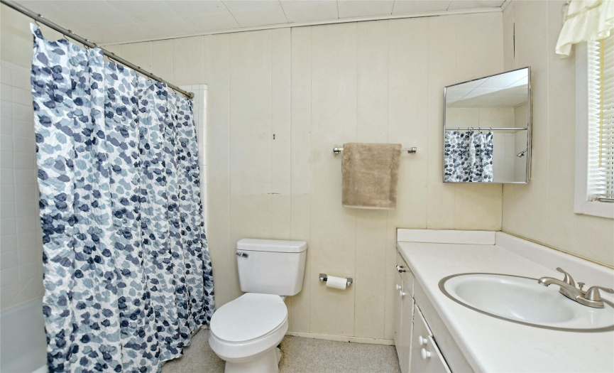 Full Bath off Vanity Area has a Tub/Shower and Single Sink.
