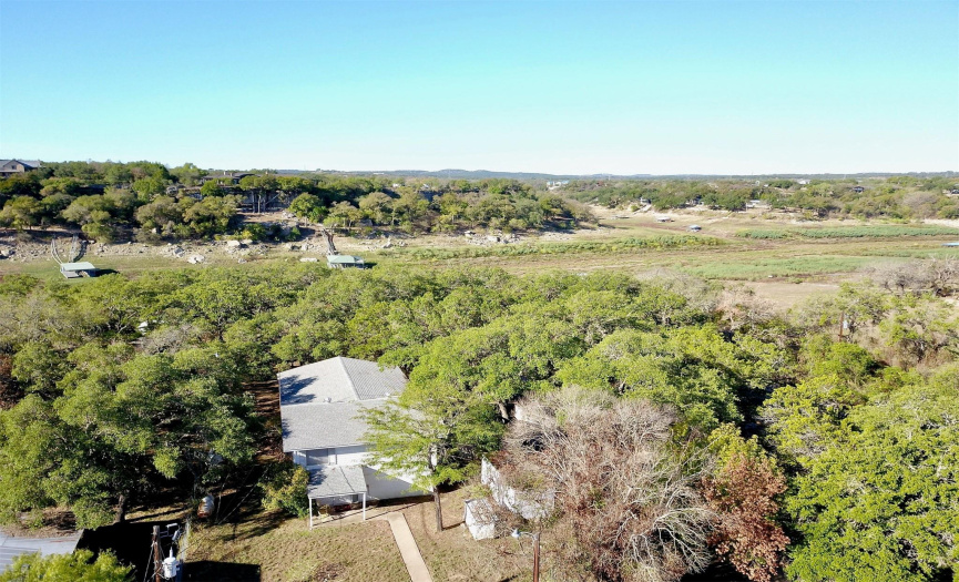 Pricing reflects an opportunity to purchase NOW while the water is low. The flat green space in the background of this photo will be the beautiful Pedernales River once the rains return to bring the levels of Lake Travis and the Pedernales back to their desired elevations.