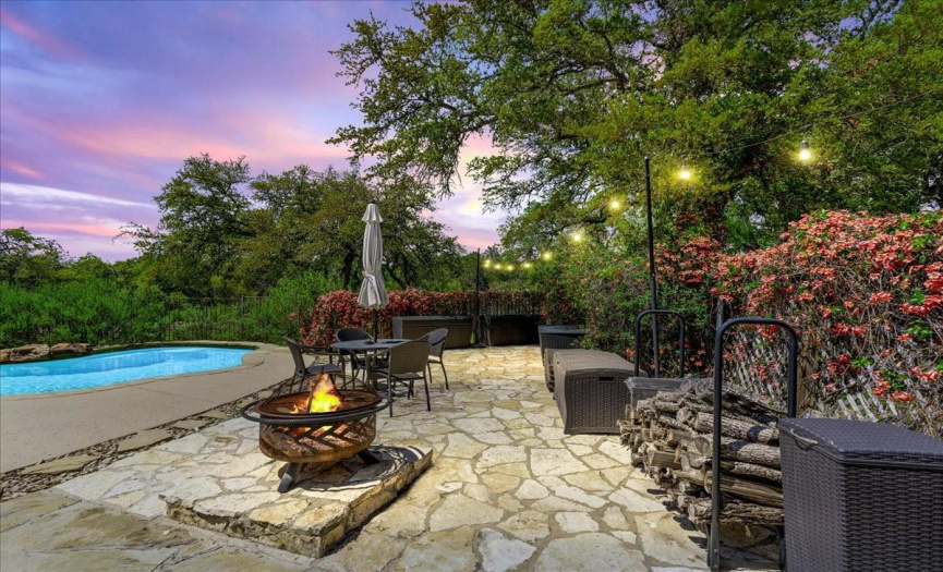 Situated on a sprawling, fully-fenced 1.889-acre lot adorned with majestic trees, this stunning property offers unparalleled privacy and breathtaking hill country views.