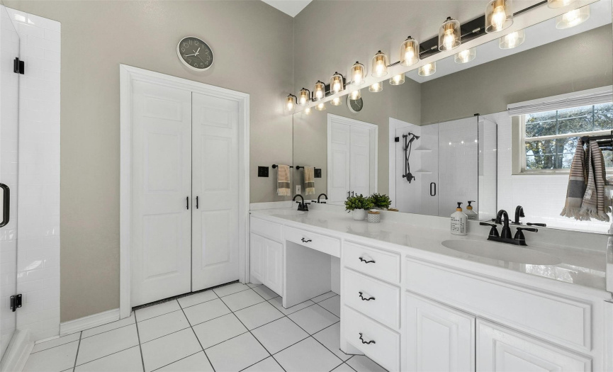 The spacious primary bathroom features a dual vanity, soaking tub, and separate walk-in shower, creating a serene spa-like retreat.