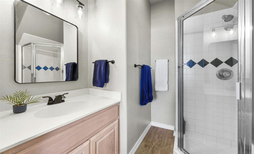 The main floor home office (or fourth bedroom) is conveniently located near a full bathroom with a walk-in shower.