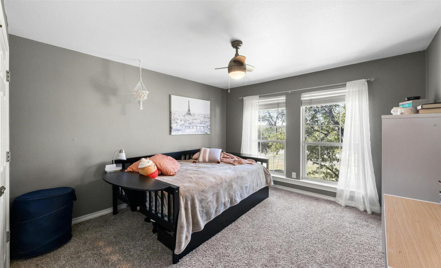 Bright and airy, the third bedroom feature large windows and a spacious closet for storage.