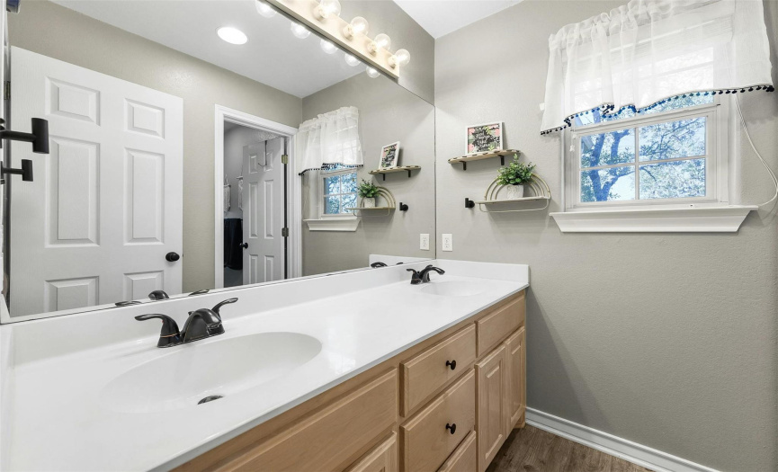 The guest bathroom features a double vanity and ensures comfort and functionality for guests.