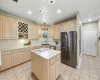 The eat-in kitchen features a center island, ample cabinetry, and a gas cooktop.