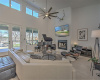 Soaring ceiling main living area with fireplace, views of lake all across the back of the home