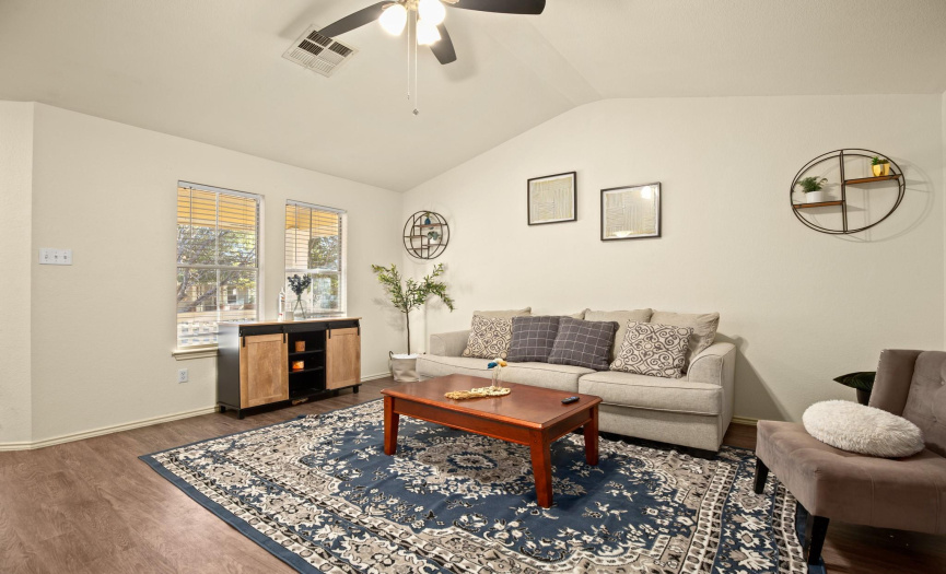 Step through the front door and into a spacious living room that exudes comfort and warmth.