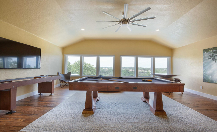 Elevate your entertainment experience in the upstairs game room, featuring stunning views and enough space for your pool table, ensuring endless fun and relaxation.
