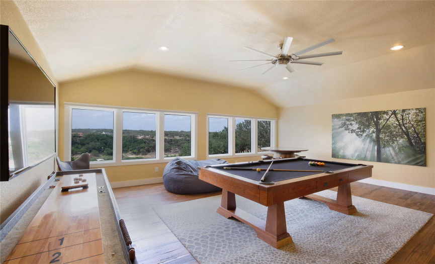 Enjoy the panoramic vistas from the upstairs game room while indulging in your favorite activities, whether it's hosting lively gatherings or unwinding with a game of pool.