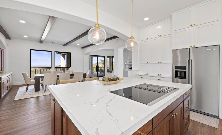 Modern, open-concept kitchen with marble countertops and state-of-the-art appliances, ideal for entertaining and luxurious living.