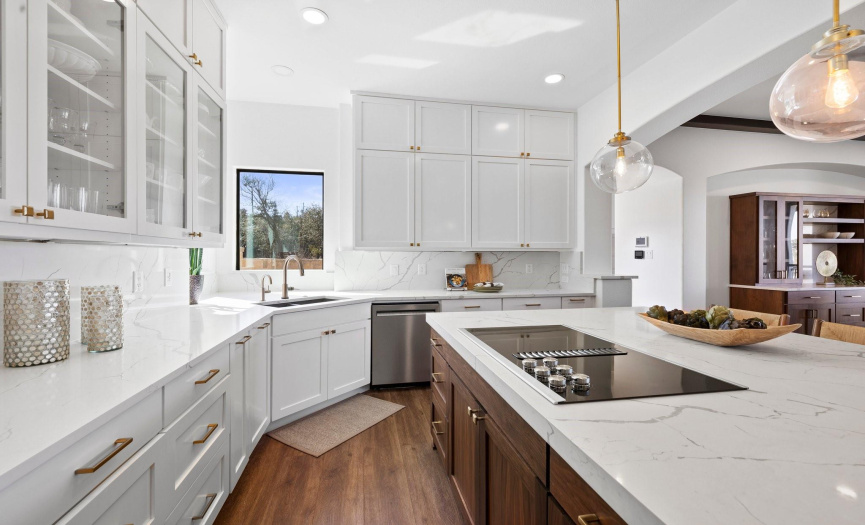 Sleek, elegant kitchen with pristine marble countertops, designer lighting, and sophisticated cabinetry, creating a culinary oasis for home chefs.