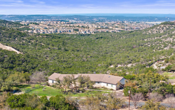 Situated in the Austin Hill Country, this secluded home offers panoramic views and tranquil living, just minutes from city conveniences.