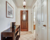 The entryway has a beautiful, solid wood door with a stained glass insert, storage closet to the right