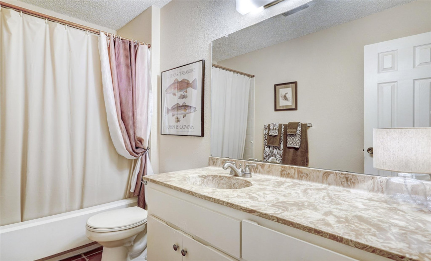 A third full bathroom is located in the hallway with the other two bedrooms