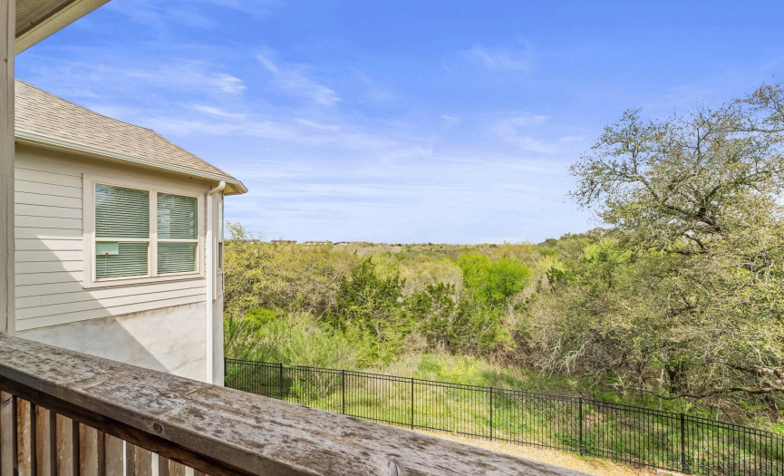 From the vantage point of the patio, lush vegetation blankets the banks of the creek, painting the scene with vibrant hues of green, while occasional bursts of colorful wildflowers add a touch of whimsy to the tableau.