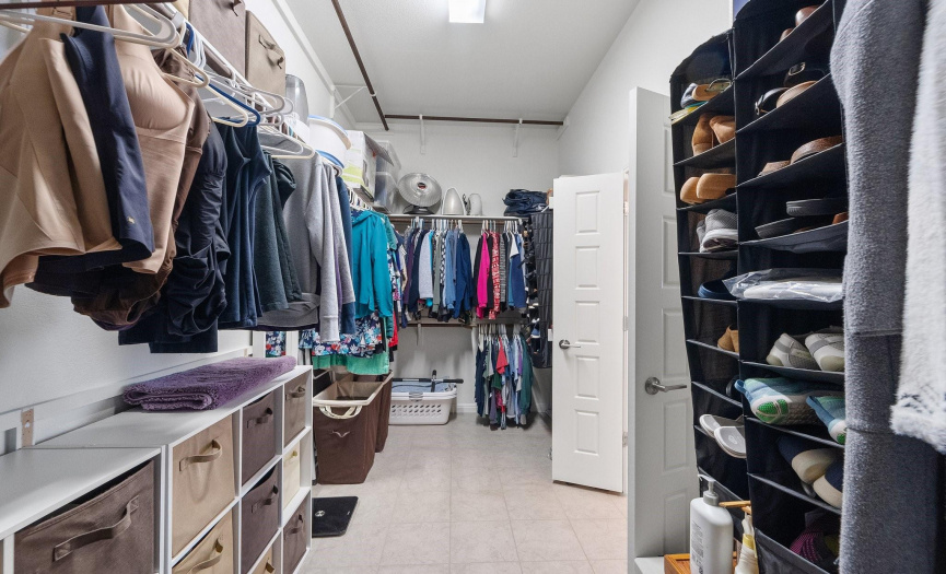 A dream walk-in closet with meticulously designed space that offers ample storage for you and your partner's wardrobe.