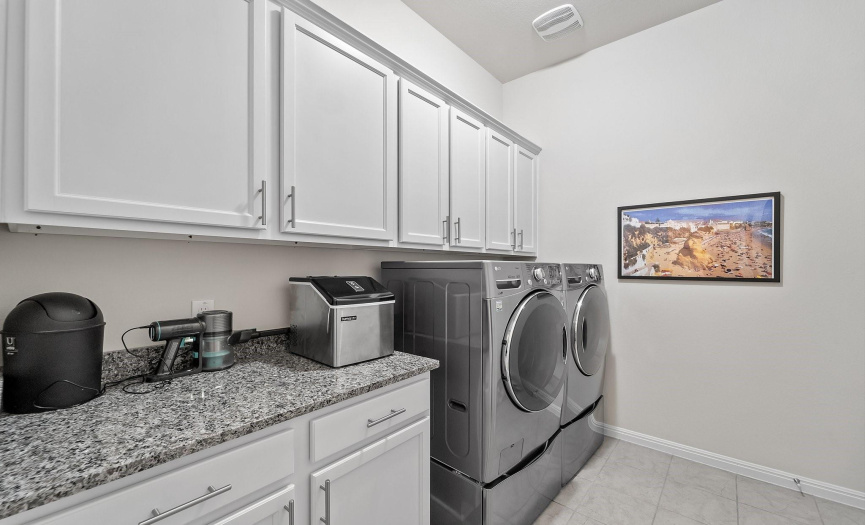 Elevate your laundry experience in this stylish and functional laundry room adorned with custom cabinets and sophisticated countertops. Every detail has been carefully curated to create a space that transcends the mundane task of laundry.