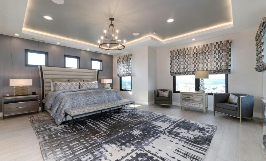 Master suite with natural lighting plus tray ceiling with recessed lighting both above and on the sides. Exquisite drapes and shades are motorized and controlled by remote. Coffee bar location with deep sink as you enter. 