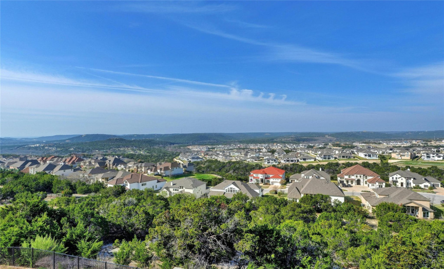 Miles and miles of hill country views. Back yard has wrought iron fence but the 1.35 acre lot goes well beyond the fence and extends to the rear neighbor's fence below. Lots of privacy and no maintenance on the lower portion of the property. 