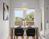 Gorgeous sunny dining area situated in oversized windows with treetop views. 