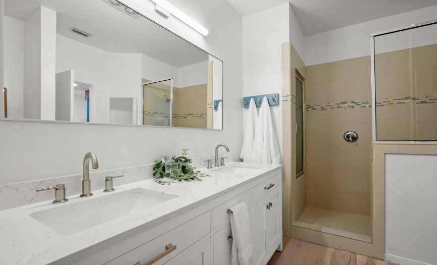 The bathroom has also been thoroughly remodeled. Featuring a contemporary dual vanity, shaker-style cabinetry, and designer Wayfair finishes. 