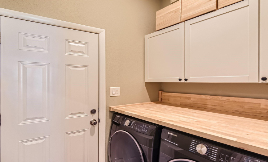 Laundry room off the kitchen, door leading to garage.