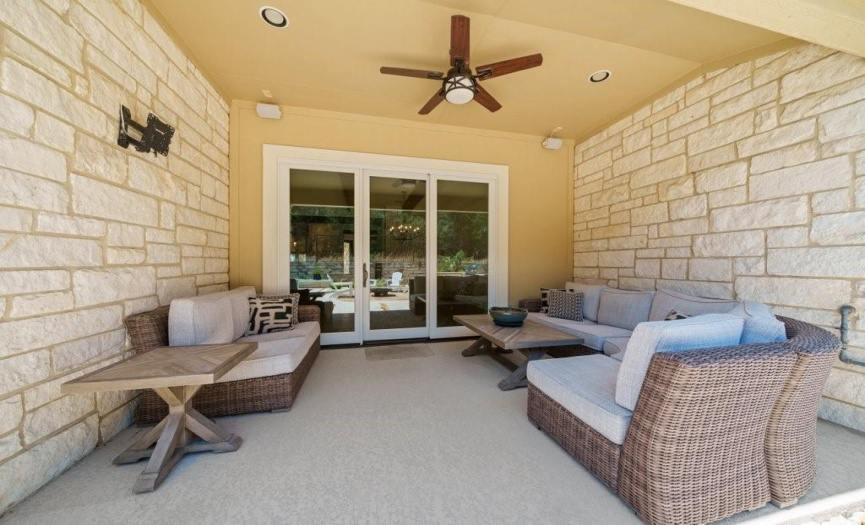 Covered patio with outdoor speakers and a large fan to keep you cool. TV mount included.