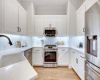 Updated in 2022, this stunning kitchen features quarts countertops, stainless steel appliances, and shaker style cabinets