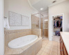 Primary bathroom with double vanity, soaking tub and walk in shower